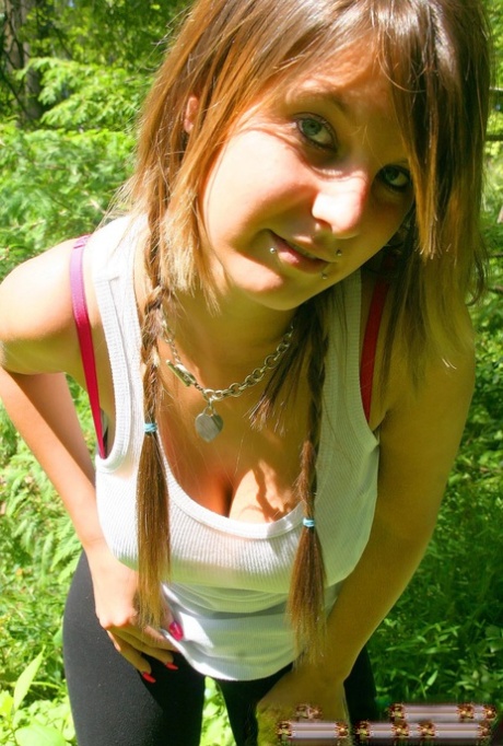 Cutie Britt Phillips in pigtails removing her top to sun her big titties