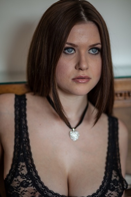 Blue-eyed brunette babe Marjana A exposes her big tits and poses naked