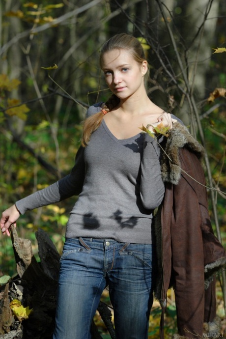 Pretty teen Irina A exposes her amazing big tits and poses naked in the woods