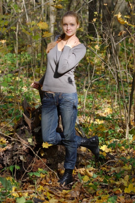 Pretty teen Irina A exposes her amazing big tits and poses naked in the woods